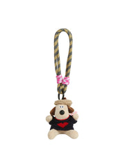 The HR Artist Dog Plush Keychain features a small dog in a heart sweater, attached to a yellow and black cord with pink and white accents—a charming gift for art lovers.
