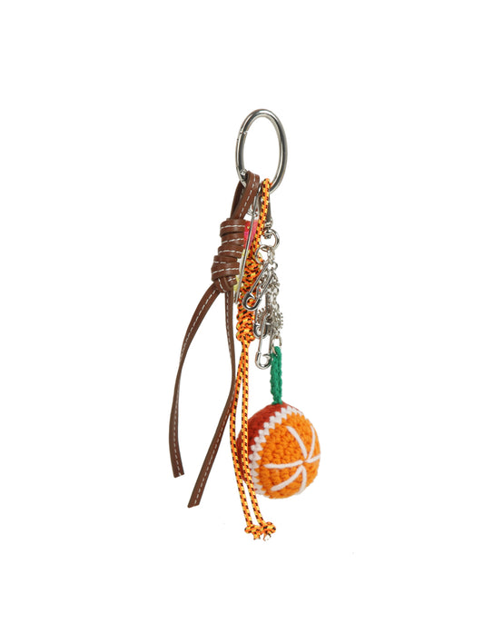 The HR Crochet Basketball Keychain features brown leather straps, orange and green cords, silver chains, and a handmade orange-and-white crochet basketball charm—ideal as a sporty bag accessory with a handy keyring clip.
