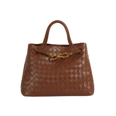 The LM Knot Accent Woven Tote is a brown faux leather handbag featuring two handles, a gold metal front clasp, and a stylish braided crossbody strap.