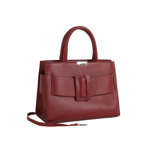 The LM Buckle Accented Structured Tote is a red leather bag with two handles, a front statement buckle detail, and a detachable crossbody strap, displayed against a white background.