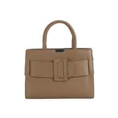 The LM Buckle Accented Structured Tote is a taupe leather handbag featuring two handles, a statement front buckle, a rectangular shape, and a detachable crossbody strap for versatile carrying.