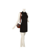 A mannequin in a sleeveless black mini dress carries the HR Aztec Crossbody Set, featuring a blue patterned strap.
