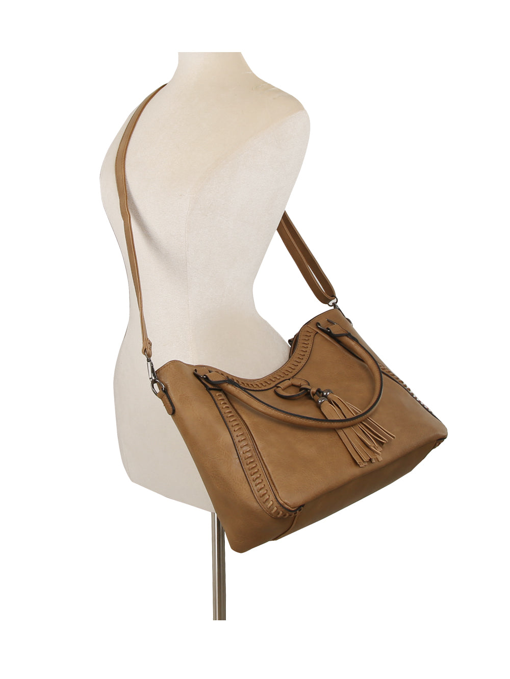The LM Whipstitch Tassel Bead Accented Shoulder Tote, featuring braided details, a tassel accent, and an adjustable crossbody strap in tan, is displayed on a neutral mannequin torso.