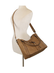 The LM Whipstitch Tassel Bead Accented Shoulder Tote, featuring braided details, a tassel accent, and an adjustable crossbody strap in tan, is displayed on a neutral mannequin torso.