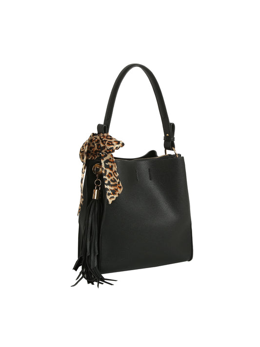 The HR Leopard Scarf Tassel Tote is a black faux leather bag with a single handle, adorned with a leopard-print scarf and black tassels on one side. It boasts a spacious interior and is shown against a plain white background.
