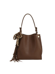 The HR Leopard Scarf Tassel Tote is a brown faux leather bag with a single handle, accented by a leopard print scarf and brown tassels, and offers a roomy interior for all your essentials.