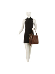 A mannequin in a sleeveless black mini dress holds the HR Leopard Scarf Tassel Tote, featuring a large faux leather design with a leopard print scarf tied to the handle.