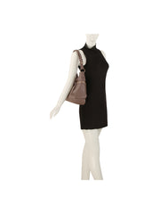 A mannequin in a sleeveless black dress carries the HR Soft Slouch Zip Shoulder Bag, a taupe faux leather style with an adjustable strap, on its left shoulder, against a plain white background.