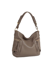 The HR Soft Slouch Zip Shoulder Bag in taupe faux leather features a short, wide strap, gold hardware, two front zippered pockets with tassel pulls, and a relaxed silhouette. Photographed against a white background.